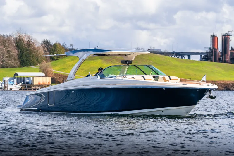 The Image of 2025 Chris-Craft Launch 35 GT boat cruising on a scenic waterway. - 0