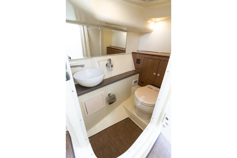 Slide: The Image of Luxurious bathroom interior of 2025 Chris-Craft Launch 35 GT boat, featuring modern fixtures and wood accents. - 10