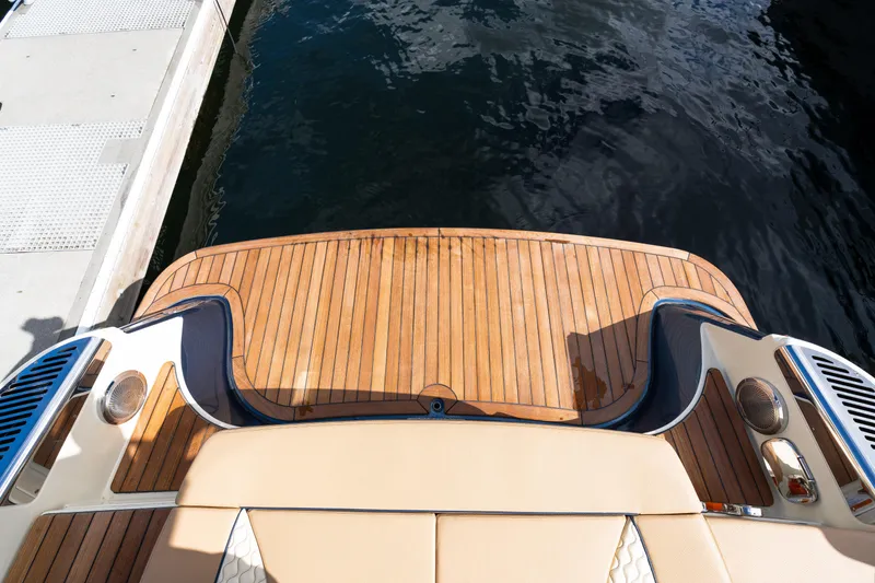 Slide: The Image of 2025 Chris-Craft Launch 35 GT boat with elegant wooden deck at dockside. - 12