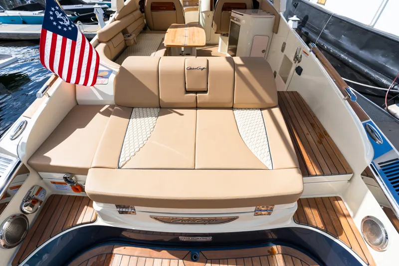 Slide: The Image of 2025 Chris-Craft Launch 35 GT boat interior with luxurious seating and American flag. - 14