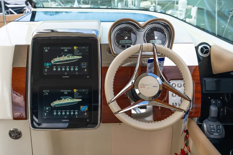 Slide: The Image of 2025 Chris-Craft Launch 35 GT dashboard with Garmin displays and steering wheel. - 22