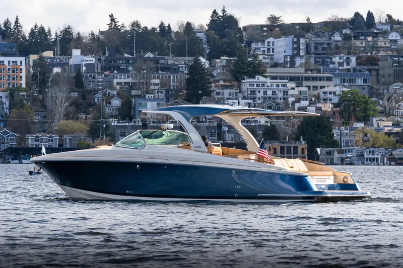 Slide: The Image of 2025 Chris-Craft Launch 35 GT boat on water with urban backdrop. - 3