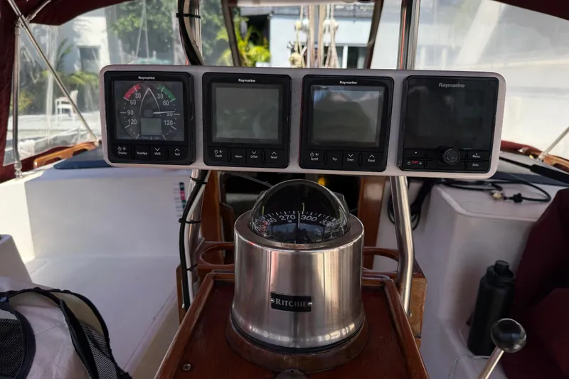 Slide: The Image of Cockpit of 1984 Stamas 44 boat featuring Raymarine navigation instruments and compass. - 13