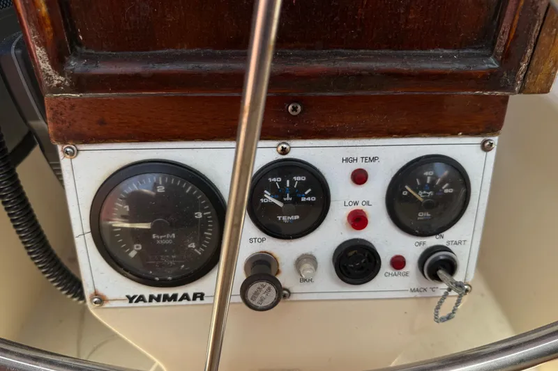 Slide: The Image of Control panel of a 1984 Stamas 44 boat featuring Yanmar gauges and switches. - 15