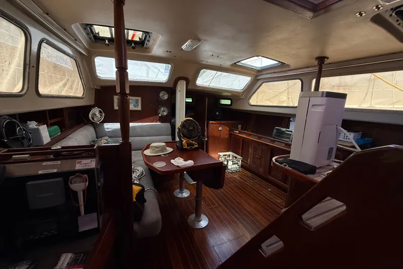 Slide: The Image of Interior of a 1984 Stamas 44 yacht with wooden flooring and cozy seating area. - 17