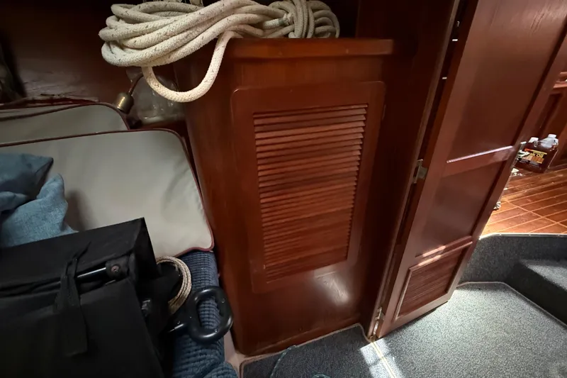 Slide: The Image of Interior of 1984 Stamas 44 boat with wooden cabinetry and nautical rope. - 25