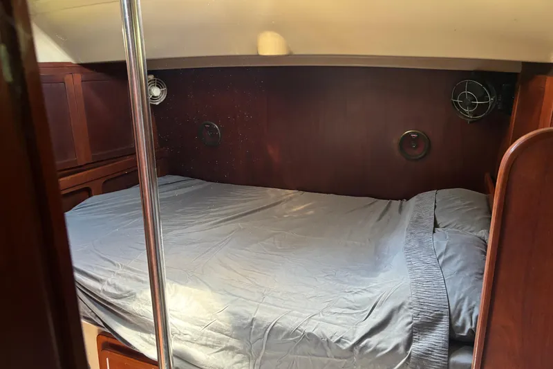 Slide: The Image of Interior cabin of a 1984 Stamas 44 boat with a neatly made bed. - 27
