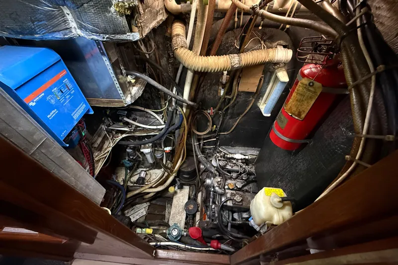 Slide: The Image of Engine room of a 1984 Stamas 44 boat with equipment and fire extinguisher. - 36