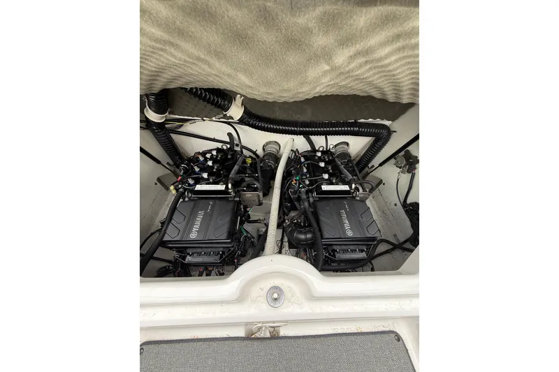 Slide: The Image of 2019 Yamaha AR210 boat engine compartment with dual engines and wiring. - 14