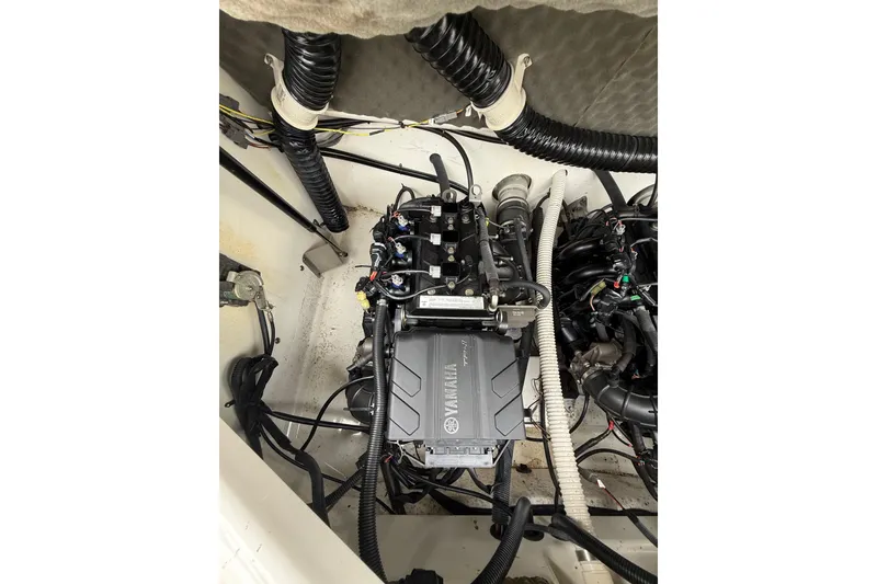 Slide: The Image of 2019 Yamaha AR210 boat engine compartment with visible wiring and components. - 15
