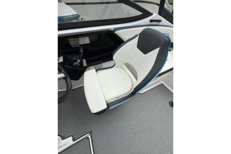 Slide: The Image of 2019 Yamaha AR210 boat interior with sleek captain's chair and steering console. - 19