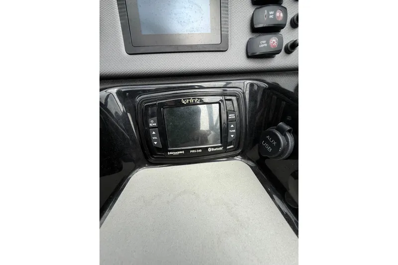 Slide: The Image of Dashboard of a 2019 Yamaha AR210 boat featuring audio controls and USB port. - 23