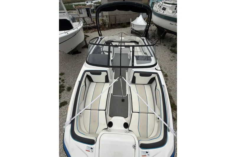 Slide: The Image of 2019 Yamaha Boats AR210 with sleek design and spacious seating, docked outdoors. - 28
