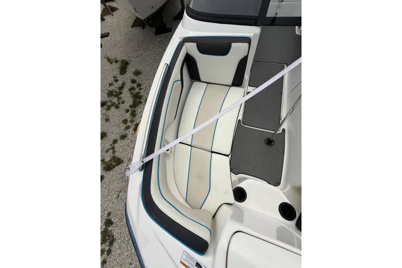 Slide: The Image of 2019 Yamaha Boats AR210 interior seating with white and blue upholstery. - 30