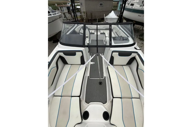 Slide: The Image of 2019 Yamaha Boats AR210 interior with white seating and sleek design. - 31
