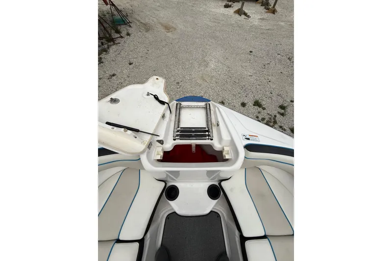 Slide: The Image of 2019 Yamaha Boats AR210 interior with seating and storage compartment. - 32