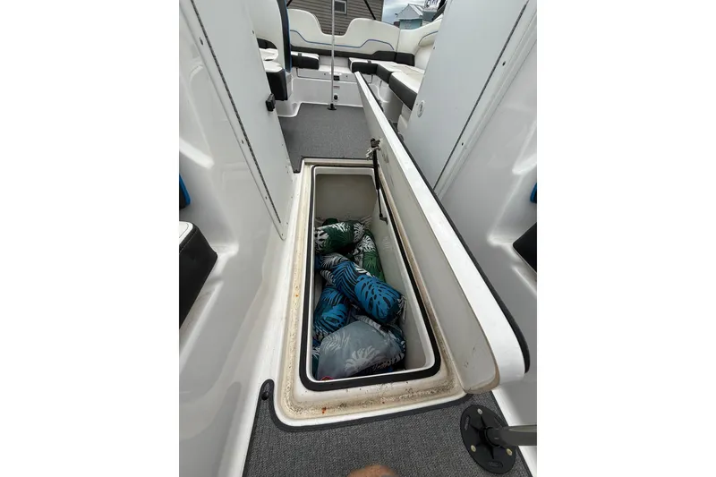 Slide: The Image of 2019 Yamaha AR210 boat interior storage compartment with colorful life jackets. - 34