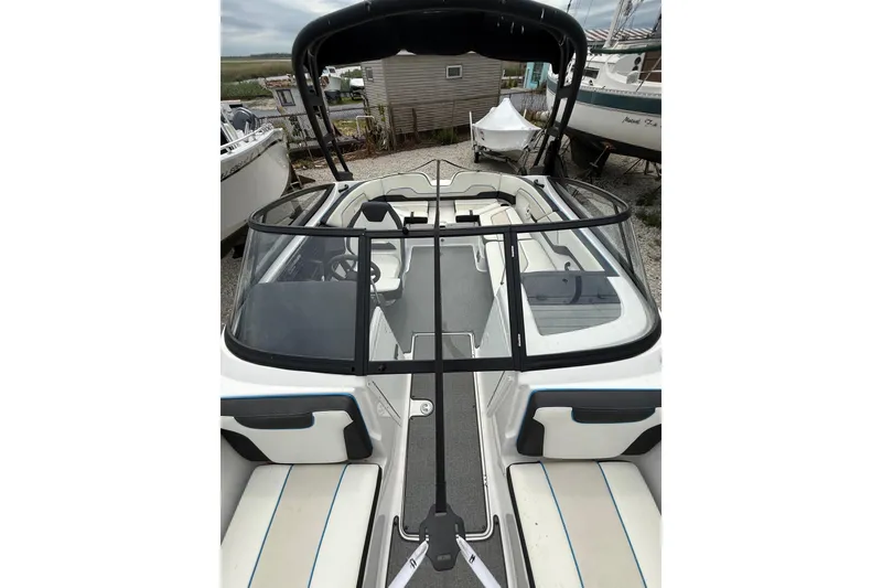 Slide: The Image of 2019 Yamaha Boats AR210 with sleek design and spacious seating, docked outdoors. - 37