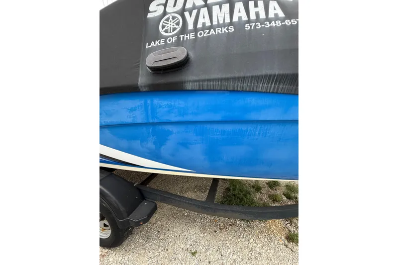 Slide: The Image of 2019 Yamaha AR210 boat on trailer, featuring blue hull and branded cover. - 7