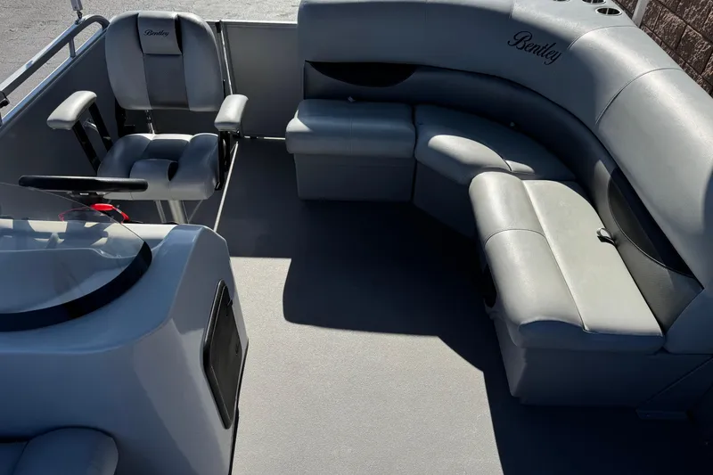 Slide: The Image of 2018 Bentley Pontoons 180 CRUISE interior with gray seating and steering console. - 15