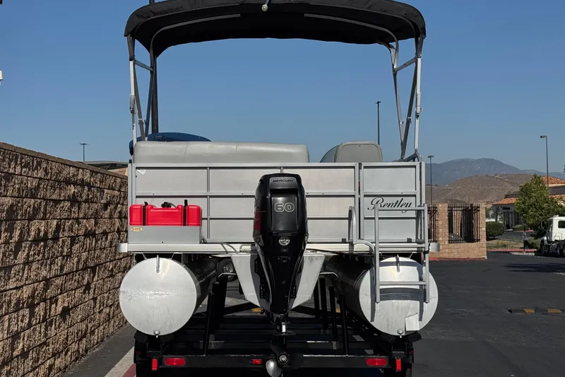 Slide: The Image of 2018 Bentley Pontoons 180 CRUISE pontoon boat with outboard motor, parked on trailer. - 5