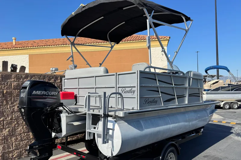 Slide: The Image of 2018 Bentley Pontoons 180 CRUISE with Mercury outboard motor, parked outdoors. - 6
