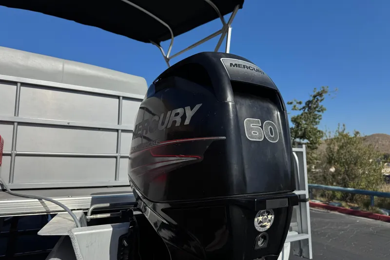 Slide: The Image of 2018 Bentley Pontoons 180 CRUISE with Mercury 60 outboard motor, parked outdoors. - 8