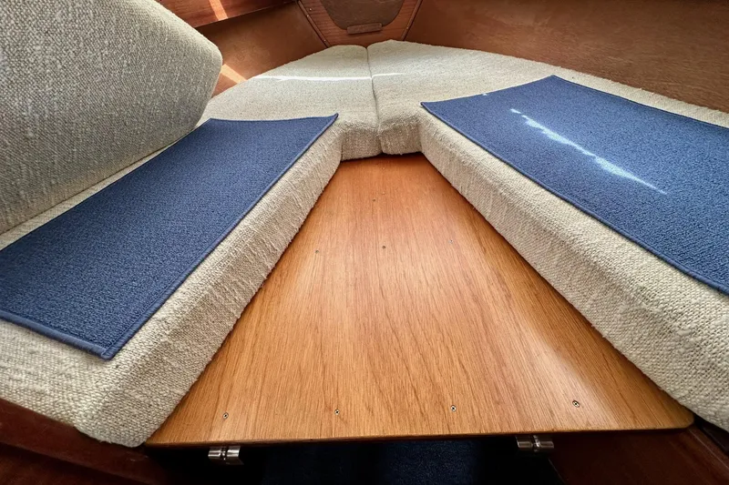 Slide: The Image of Interior cabin view of a 1973 Albin 25 boat with cushioned seating. - 5