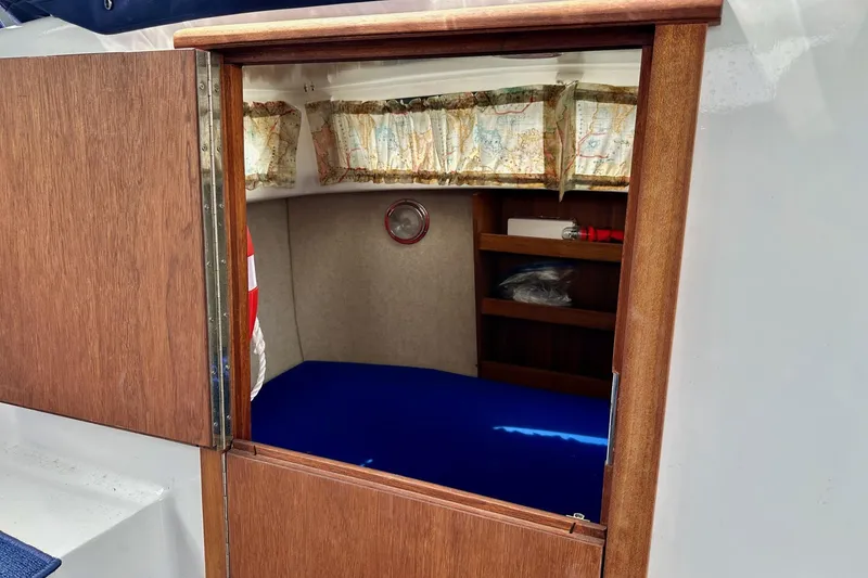 Slide: The Image of Interior cabin of a 1973 Albin 25 boat with wooden door and nautical decor. - 6
