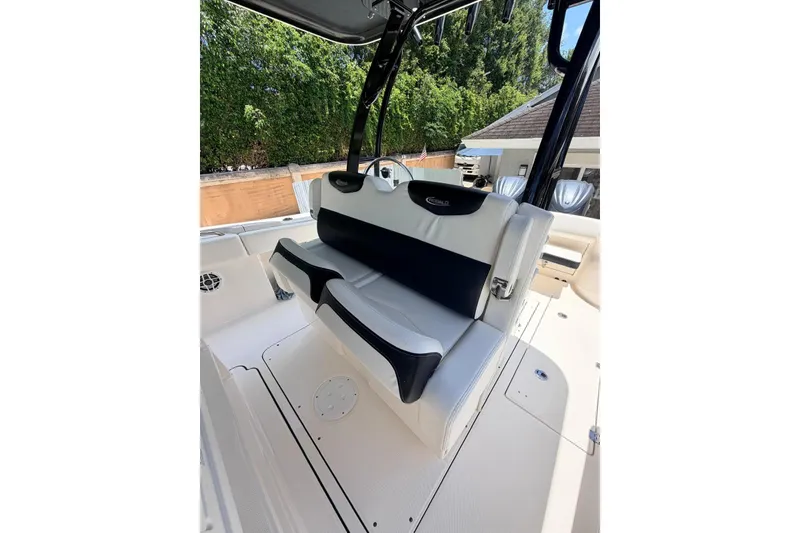 Slide: The Image of 2022 Robalo R302 Center Console boat interior with cushioned seating and sleek design. - 10