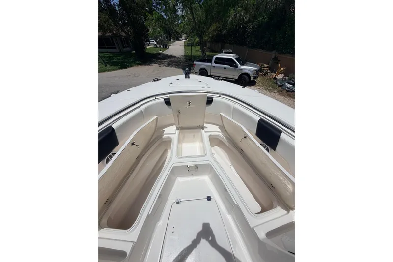 Slide: The Image of 2022 Robalo R302 Center Console boat interior with open storage compartments. - 14