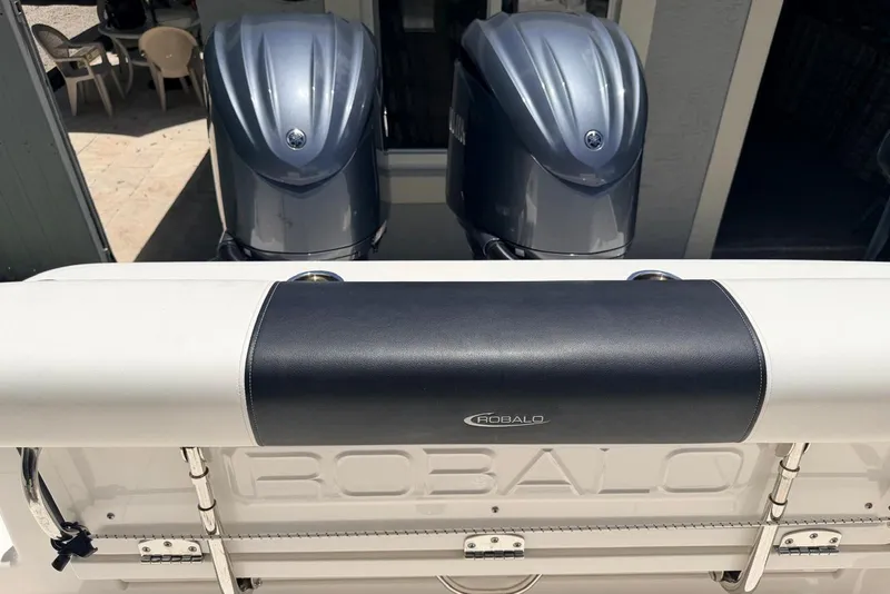 Slide: The Image of 2022 Robalo R302 Center Console boat with dual outboard engines. - 18