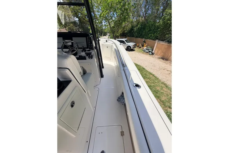 Slide: The Image of 2022 Robalo R302 Center Console boat interior with steering wheel and console view. - 19