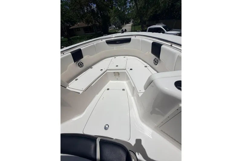 Slide: The Image of 2022 Robalo R302 Center Console boat interior with seating and storage compartments. - 20