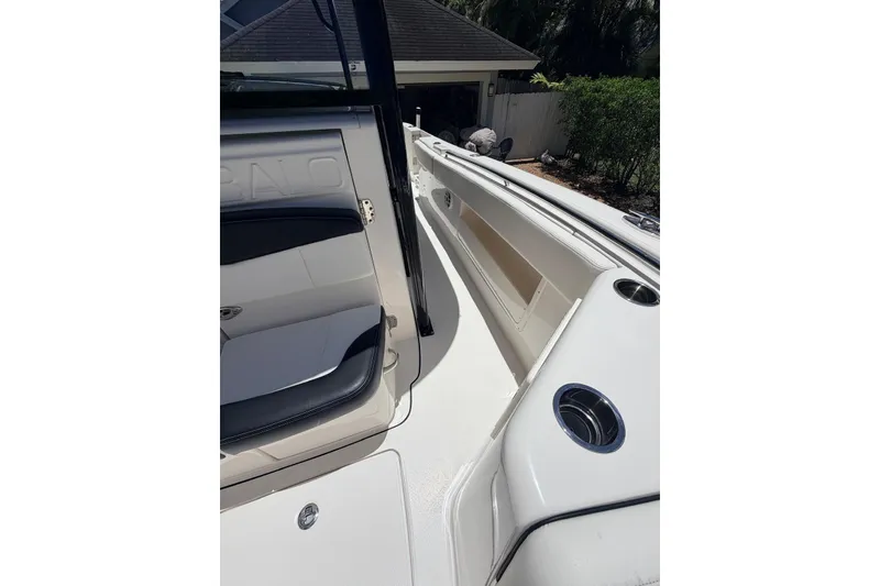 Slide: The Image of 2022 Robalo R302 Center Console boat interior with seating and cup holders. - 23