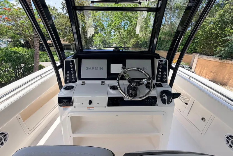 Slide: The Image of 2022 Robalo R302 Center Console boat dashboard with Garmin navigation system. - 6