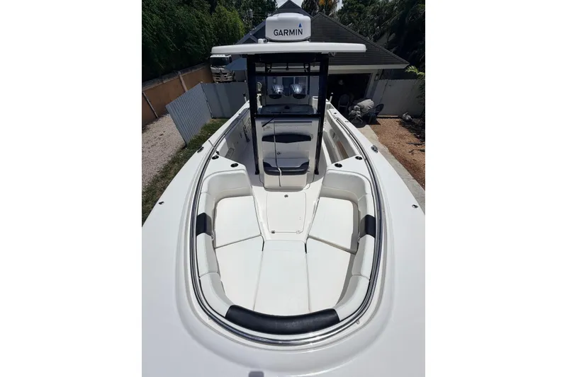 Slide: The Image of 2022 Robalo R302 Center Console boat with Garmin navigation system, docked outdoors. - 7