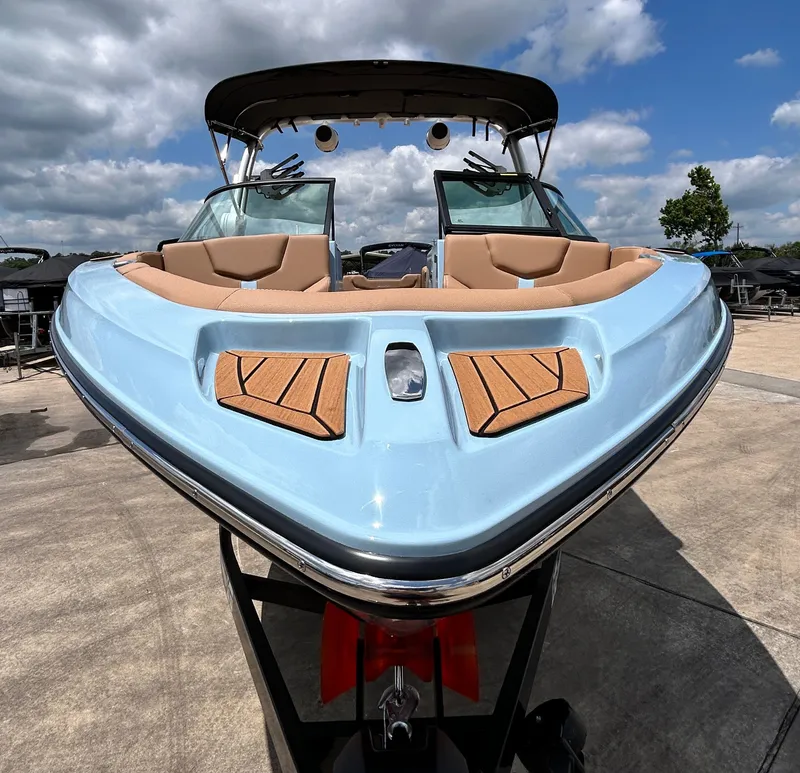 Slide: The Image of 2026 MasterCraft XT23 boat with blue hull and luxurious interior. - 10