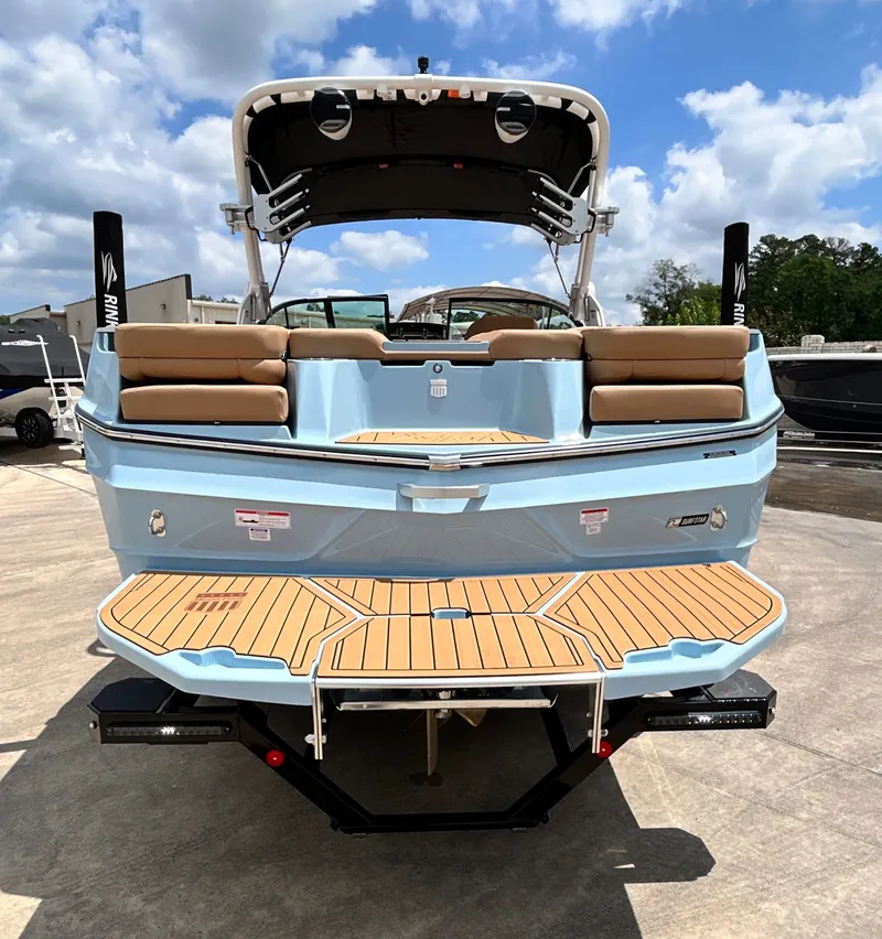 Slide: The Image of Rear view of 2026 MasterCraft XT23 boat on a parking lot. - 12
