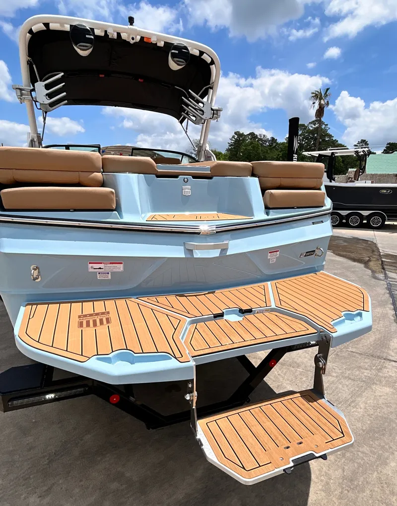 Slide: The Image of Rear view of 2026 MasterCraft XT23 boat with teak platform. - 13