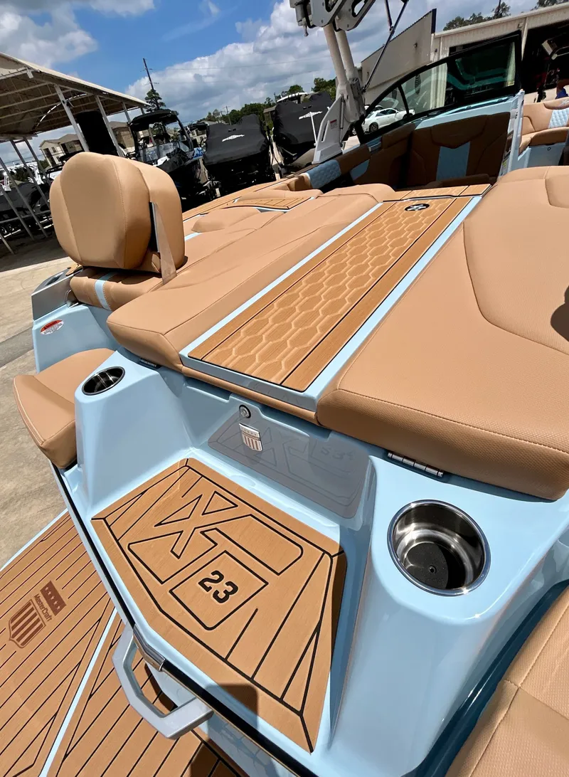 Slide: The Image of 2026 MasterCraft XT23 boat with luxurious deck design. - 14