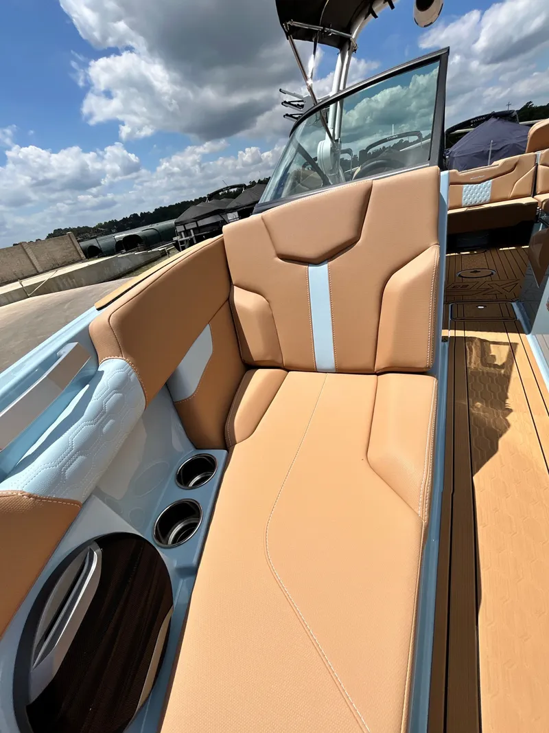 Slide: The Image of 2026 MasterCraft XT23 interior with beige seats and blue accents. - 21