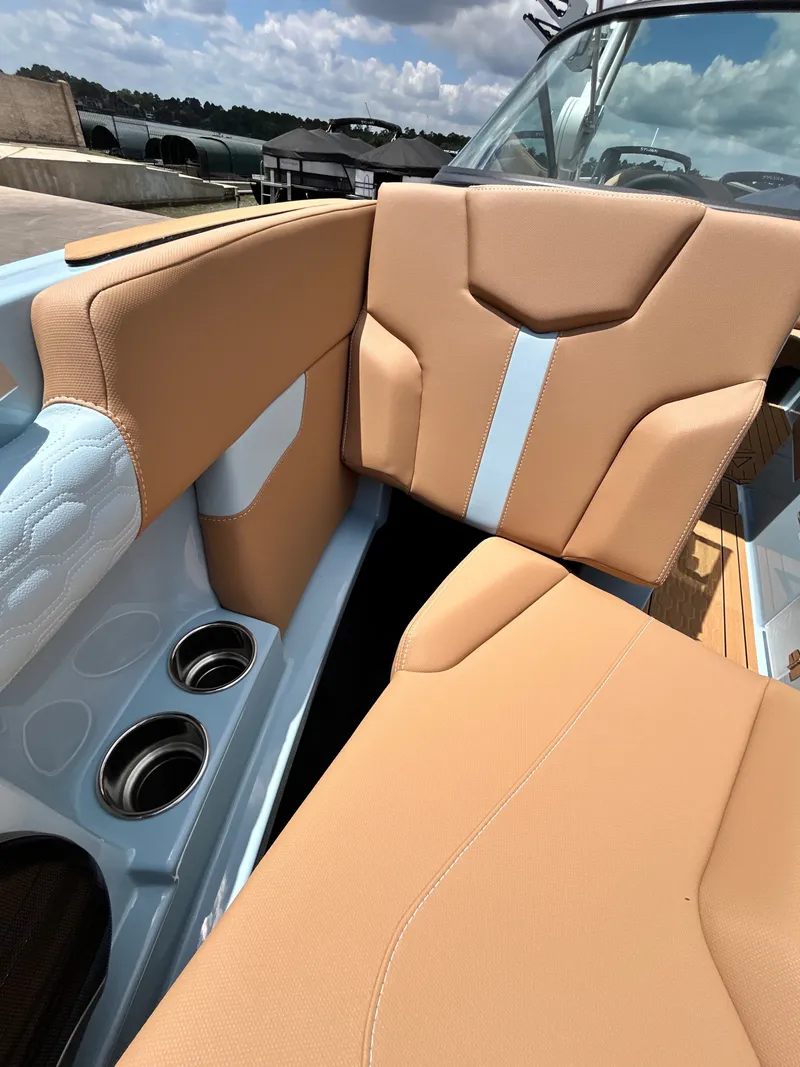 Slide: The Image of Interior of 2026 MasterCraft XT23 with beige seats and cup holders. - 22