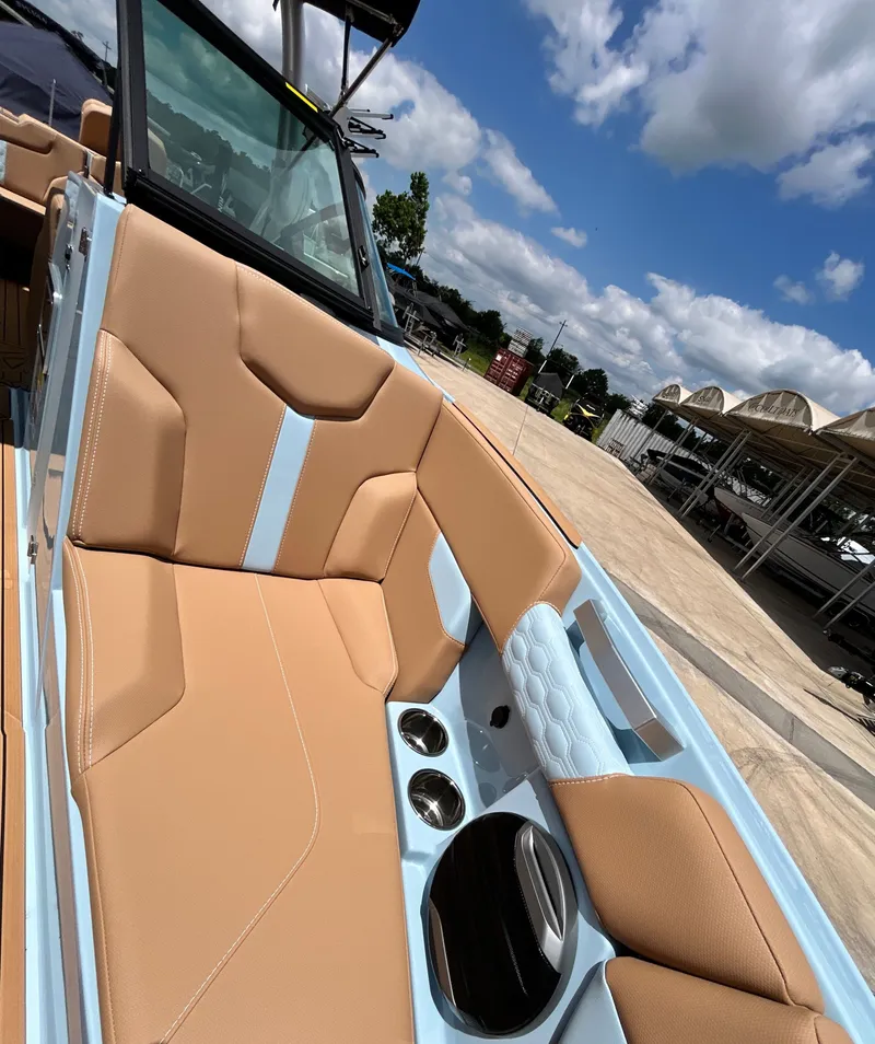 Slide: The Image of 2026 MasterCraft XT23 boat with luxurious interior and blue sky. - 23