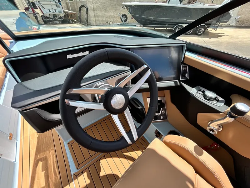 Slide: The Image of Interior of 2026 MasterCraft XT23 with modern steering wheel and dashboard. - 28