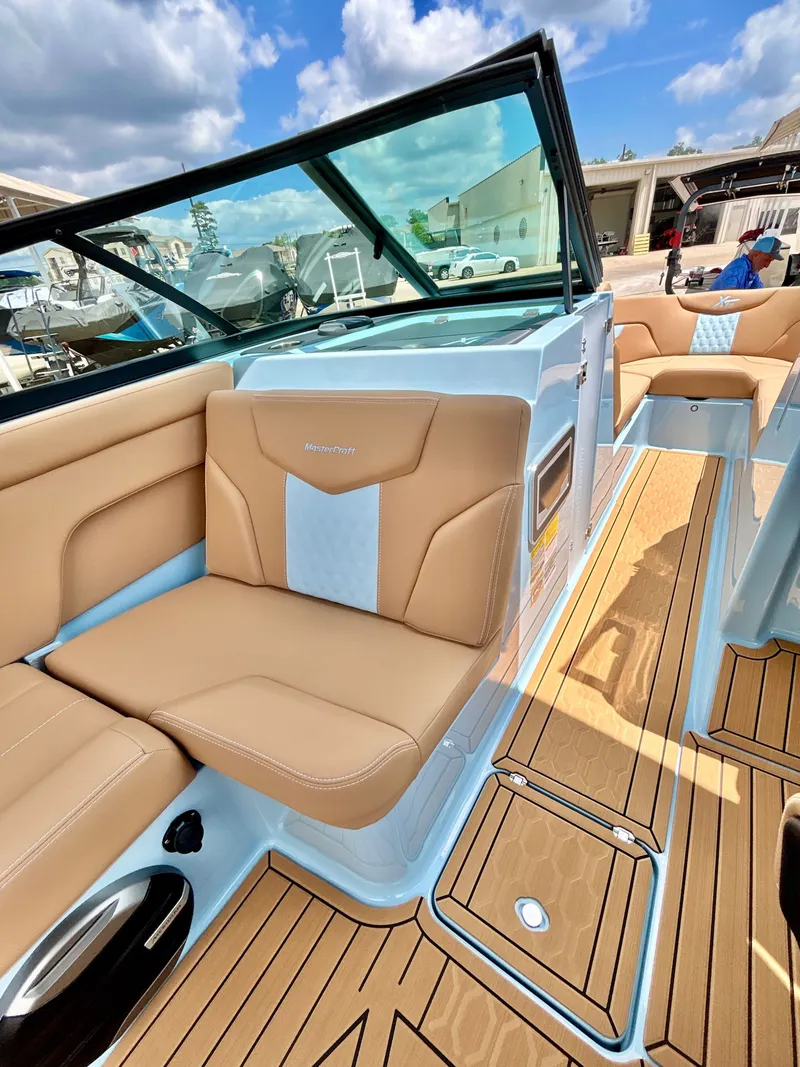 Slide: The Image of Interior of 2026 MasterCraft XT23 with luxurious seating and wood flooring. - 35