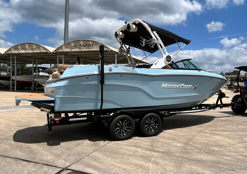 Slide: The Image of 2026 MasterCraft XT23 boat on trailer in sunny weather. - 7