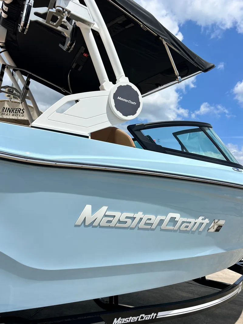Slide: The Image of 2026 MasterCraft XT23 boat with blue hull and modern design. - 9