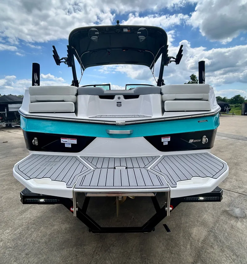Slide: The Image of Rear view of 2026 MasterCraft XT22 boat on a parking lot. - 11