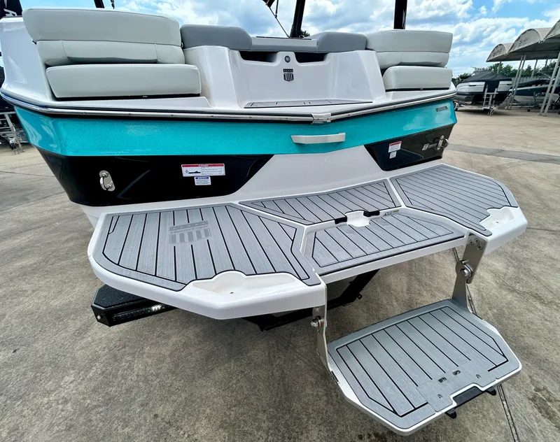 Slide: The Image of Rear view of 2026 MasterCraft XT22 with gray deck and turquoise accent. - 14